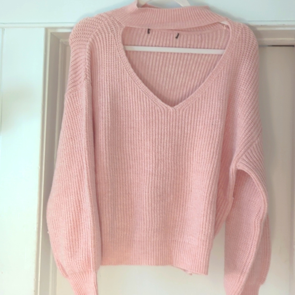 An open shaped heart turtleneck band sweater.